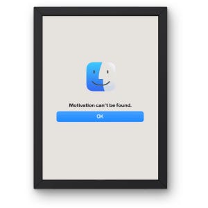 May include: A framed print featuring a stylized computer icon with a blue and white face. The text "Motivation can't be found." appears above a blue "OK" button. The frame is black.