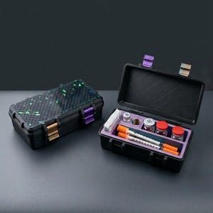 May include: Two black, rectangular cases with colorful accents. One case is closed, featuring a patterned lid with green and blue specks. The other case is open, revealing medical supplies, including vials, syringes, and a purple interior.
