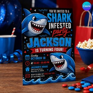 May include: A rectangular party invitation card featuring two blue sharks with sharp teeth on a black background. The text reads: You're invited to a shark infested party, Jackson is turning four, Sunday October 18, at 02:00-05:00 PM, Jackson's house 284 Coral Drive, Bayview, FL 32541, RSVP to Emily at (555) 284-7316 by October 10th.