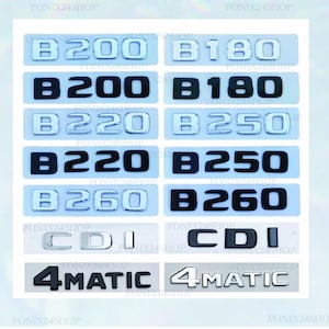 May include: A selection of car badges featuring model designations such as "B200", "B180", "B220", "B250", and "B260", alongside "CDI" and "4MATIC". The badges are in silver and black, with a rectangular design. The background is light blue.