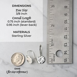 May include: Sterling silver earrings with a hammered disc design. The disc size is 3/8 inch, and the overall length is 0.75 inch (standard) or 0.95 inch (lever-back). A dime is included for size reference.