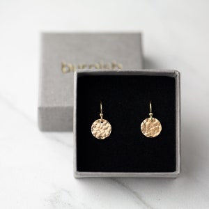 Small hammered gold filled disc earrings in a gray burnish jewelry gift box.