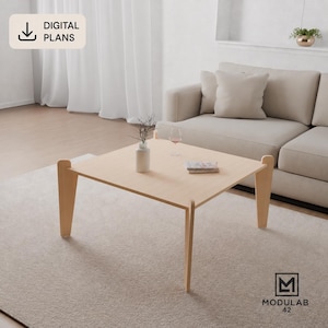 May include: A square light-colored wooden coffee table with four outward-angled legs. The table surface holds a white vase with thin branches, a clear glass, and a small stack of papers. A digital plans icon and the text MODULAB 42 are visible.