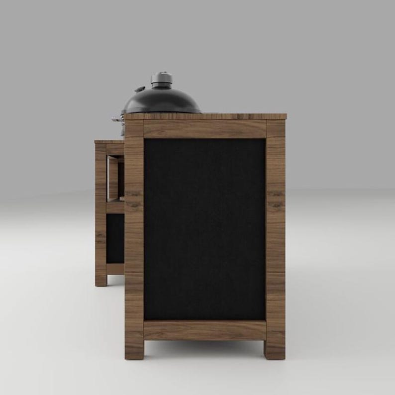 May include: A wooden outdoor kitchen island with a dark brown wood grain finish and black rectangular panels. The structure features a side shelf and a black dome-shaped grill lid resting on the top surface, showcasing a sturdy frame construction.