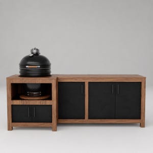 May include: A black ceramic kamado-style grill sits on a wooden outdoor kitchen island. The island features a natural wood frame with matte black cabinet doors and vertical handles, providing storage space beneath the grill and to the side.