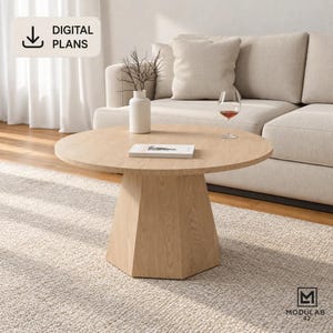 May include: A round light wood coffee table with a hexagonal pedestal base. On the table sits a white vase with thin branches and a book. A glass of red wine is placed next to the book. The image includes the text DIGITAL PLANS and MODULAB 42.