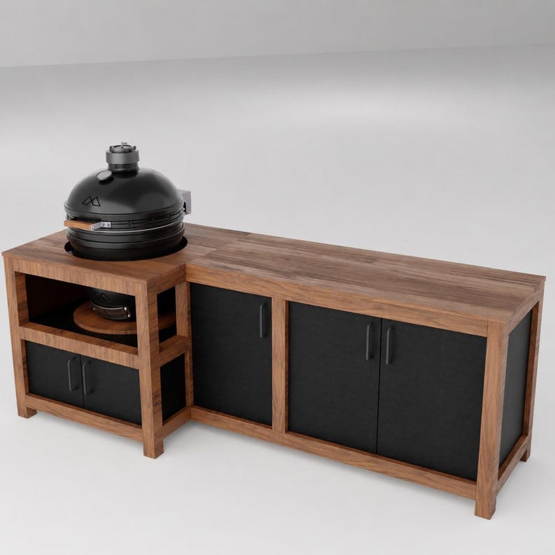 May include: A black ceramic kamado grill sits on a wooden outdoor kitchen island. The island features a natural wood countertop, a lower shelf for the grill, and three black cabinet doors with vertical handles, providing storage space.