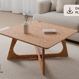 May include: A square wooden coffee table with a light brown grain finish and a cross-shaped base. The table surface holds a white vase with thin branches, a wine glass, and a book. A label in the corner reads DIGITAL PLANS and MODULAB 42.