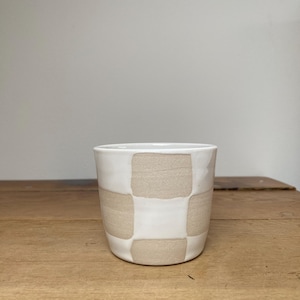 Handmade ceramic white and natural checkered cup.  Approx 180ml