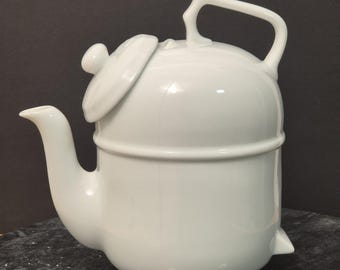 Tetera de porcelana vintage Ronnefeldt con calentador – Elegante juego de té blanco, diseño alemán.