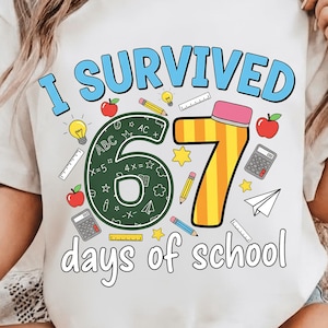 May include: White t-shirt with the text "I SURVIVED 67 days of school" in blue and yellow. The design includes a large number 67, apples, pencils, light bulbs, and a calculator.