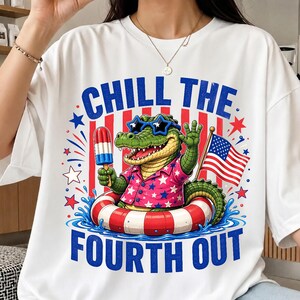 May include: White t-shirt with a graphic of an alligator wearing sunglasses and a Hawaiian shirt, holding a popsicle and an American flag. The text "CHILL THE FOURTH OUT" is displayed in blue.