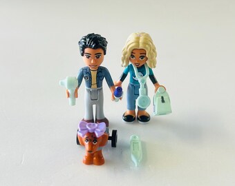 LEGO Friends mini-doll figures, specifically Dr. Marlon and Alycia, from the Dog Rescue Van