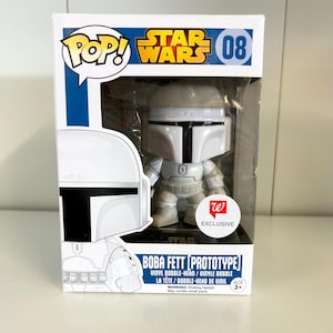 May include: A white Boba Fett [Prototype] vinyl bobble-head figure from Star Wars, displayed in its original box. The box features the Pop! and Star Wars logos, with the number 08. The figure is a Walgreens exclusive.