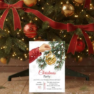 May include: A Christmas party invitation featuring a hand holding a gold and white ornament on a snowy evergreen branch. The invitation text reads "Christmas Party" with event details, set against a backdrop of a decorated Christmas tree with red bows and ornaments.
