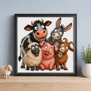 May include: A framed cross-stitch artwork featuring a group of cartoon farm animals including a black and white cow, a grey donkey, a cream-coloured sheep, a pink pig, and a brown goat, all arranged together against a white grid background.