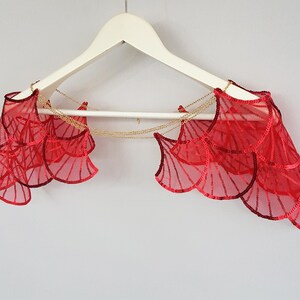 Red sequin wing bridal cape on hanger, statement shoulder piece for bold wedding look