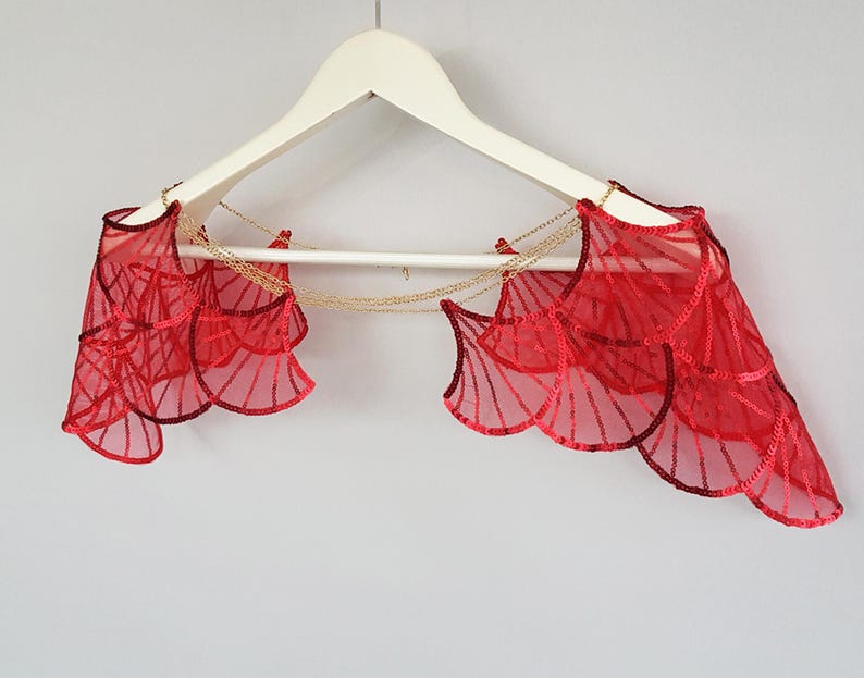 Red sequin wing bridal cape on hanger, statement shoulder piece for bold wedding look