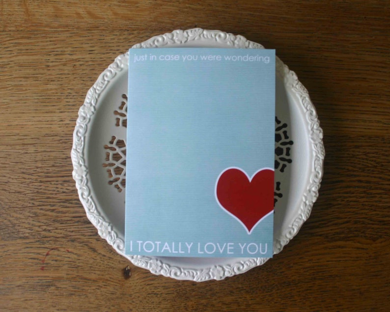 May include: A light blue card with the text "just in case you were wondering" and "I TOTALLY LOVE YOU". A red heart is in the center of the card.