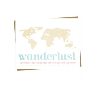 May include: A white card with a beige outline of the world map and the text "wanderlust" in light blue. Below the text, it says "spending this beautiful life getting lost together" in pink.