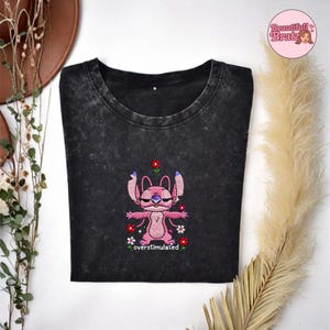 May include: A handmade wooden sign displaying the word "Welcome" in a whimsical font. The sign has a distressed white backdrop and a dark stained wooden frame, ideal for adding rustic charm to a doorway.