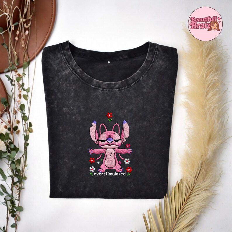 May include: A handmade wooden sign displaying the word "Welcome" in a whimsical font. The sign has a distressed white backdrop and a dark stained wooden frame, ideal for adding rustic charm to a doorway.