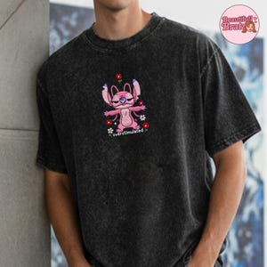 May include: A white ceramic mug with a black handle and the text "But First, Coffee" in a black, handwritten-style font. The mug is on a white surface.