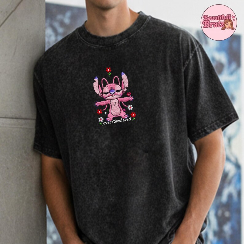 May include: A white ceramic mug with a black handle and the text "But First, Coffee" in a black, handwritten-style font. The mug is on a white surface.