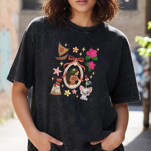 Pode incluir: Camiseta preta com um design gr&aacute;fico colorido. O design inclui um retrato de uma mulher, um barco, flores e outros elementos tropicais. A camiseta &eacute; feita de um material macio e confort&aacute;vel.