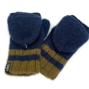 May include: A pair of navy blue and olive green convertible mittens featuring a textured knit pattern, a fold-over flap secured by a small navy button, and a black fabric tag with the white text "laine's" attached to the ribbed cuff edge.