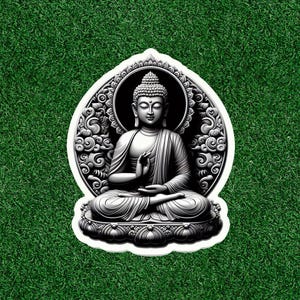 May include: A black and white sticker featuring a detailed illustration of a seated Buddha statue. The Buddha is in a meditative pose, surrounded by an ornate, decorative frame. The sticker is set against a green background.