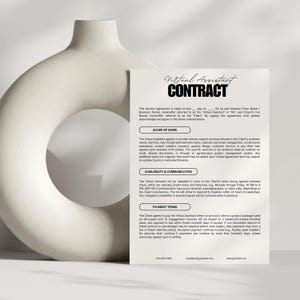 May include: A white document titled "Virtual Assistant CONTRACT" with detailed text, including sections on scope of work, availability, communication, and payment terms. The document is set against a neutral background with a decorative vase.