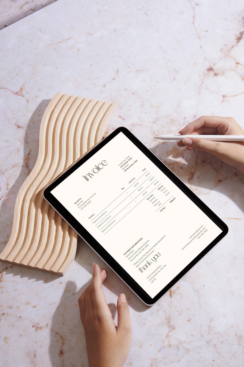 May include: A digital invoice on a tablet with the word "invoice" at the top. The invoice includes product details and a total. A wooden decorative piece and a stylus are also in the image.