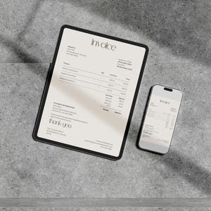 May include: A digital invoice displayed on a tablet and smartphone. The tablet shows the word "invoice" at the top, with product details and a total. The smartphone mirrors the invoice. Both devices are on a gray surface.