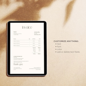 May include: A digital tablet displays an invoice with the word "invoice" at the top. The invoice includes product details, payment information, and the words "thank you". The tablet is on a light brown surface.