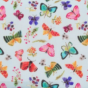May include: A light blue fabric with a repeating pattern of colorful butterflies and flowers. The butterflies are in various shades of blue, green, pink, red, and orange. The flowers are in shades of pink, purple, and yellow.