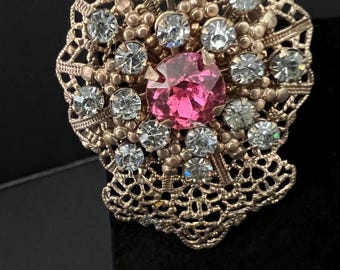 Vintage Silver-Tone Rhinestone Brooch with a Pink Center Stone and Filigree Design