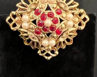Vintage Gold-Tone Brooch Featuring a Floral-Inspired Design with Red Rhinestones and Faux Pearls