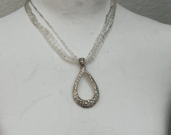 Vintage Avon Classic Necklace Featuring a Textured Silvertone Teardrop Pendant on a Multi-Strand Beaded Chain