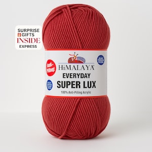 May include: A ball of red Himalaya Everyday Super Lux yarn. The label reads "Anti-Pilling!" and "100% Anti-Pilling Acrylic." The text "SURPRISE GIFTS INSIDE EXPRESS" is also visible.