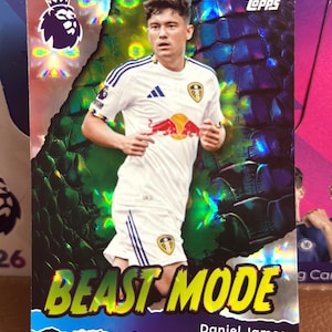 May include: A Topps trading card featuring Daniel James in a white soccer uniform with blue accents. The card has a holographic background with the text "BEAST MODE" and the Premier League logo. The Topps logo is in the upper right corner.