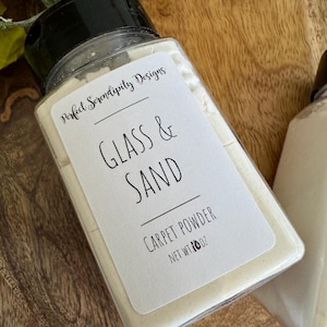 May include: A set of three ceramic mugs with a speckled, matte finish. The mugs are in shades of cream, light gray, and dark gray. Each mug has a simple, minimalist design and a rounded handle.