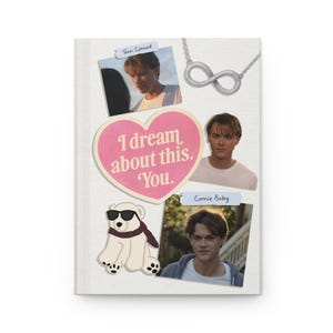 May include: A white journal with a collage of images and text. The collage includes photos of a young man, a pink heart with the text "I dream about this. You.", a polar bear wearing sunglasses, and an infinity symbol necklace.