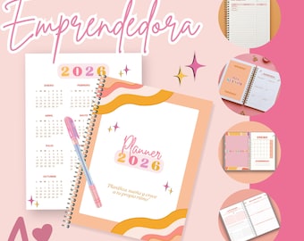 May include: A planner with the text "Planner 2026" and "Emprendedora" in pink and orange. The planner has a spiral binding and includes a calendar, with the text "Planifica, sueña y crece a tu propio ritmo".