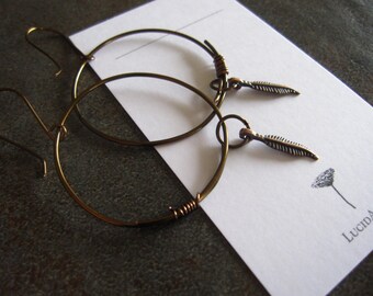 Antiqued bronze hammered hoop with copper feather charm earrings