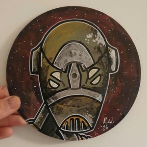May include: A circular vinyl record painted with a stylized character featuring a green and grey helmet with a yellow grill. The background is a deep red with white speckles resembling stars. The artist signature R.W. '26 is in the bottom right.