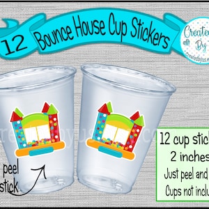 May include: Twelve 2-inch bounce house cup stickers. The stickers feature a colorful cartoon bounce house with a blue, yellow, and green color scheme. The text "Just peel and stick" is written below the stickers. Cups are not included.