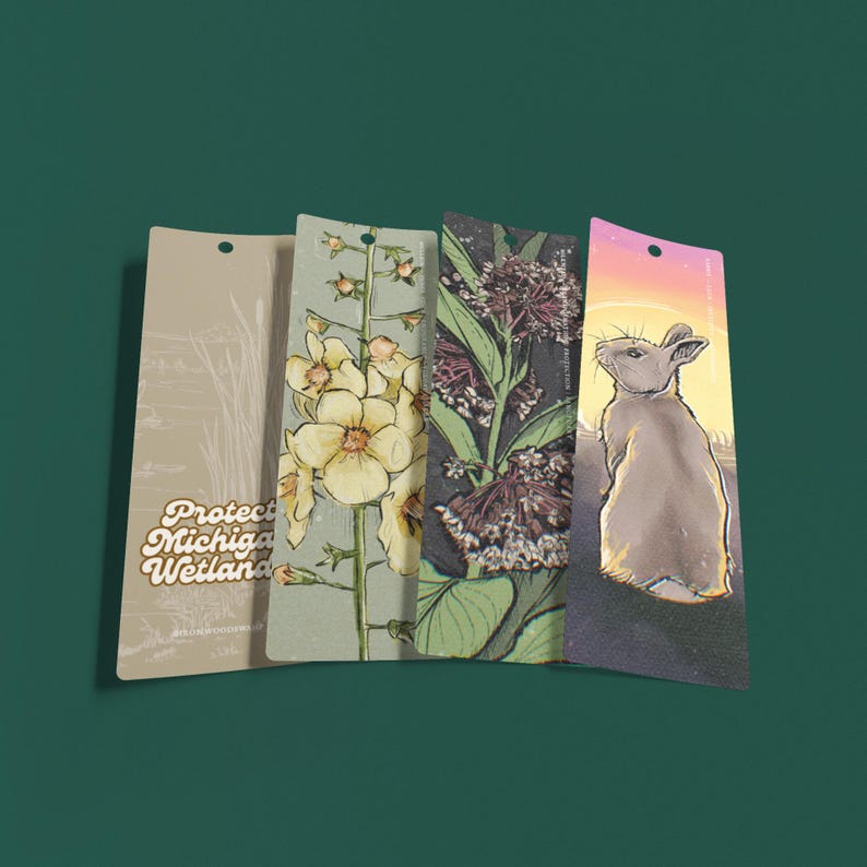May include: Four rectangular bookmarks with nature-themed illustrations. One bookmark features a rabbit silhouette against a sunset, another displays a floral design, and a third shows a plant with dark purple flowers. The first bookmark has the text "Protect Michigan Wetland".