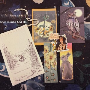 May include: A collection of illustrated items, including a drawstring bag with a swamp scene, a card with yellow flowers, a sticker with a woman, and bookmarks with an owl and a rabbit. The text "Kickstarter Bundle Add On" is visible.