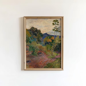 May include: A framed landscape painting with a warm color palette. The artwork depicts a lush, green hillside with trees and a path leading towards a body of water. The sky is a mix of blue and white, and the frame is a light brown.